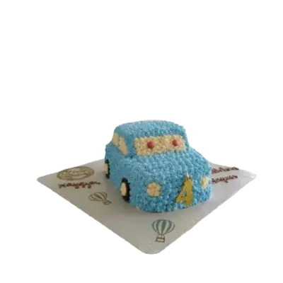 A car-shaped birthday cake decorated with textured light blue piping. The cake features a gold number 4 candle, cream-colored windows, and small red and yellow details, sitting on a white cake board."
