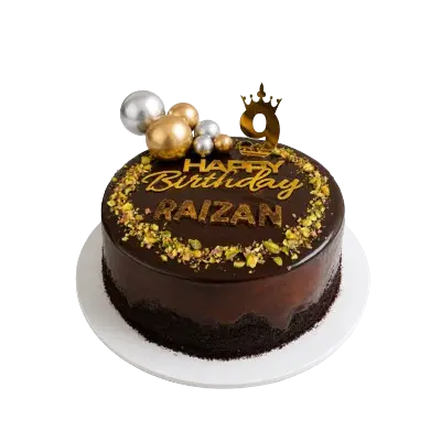A beautifully decorated chocolate birthday cake with luxurious gold and silver embellishments.